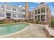 Inviting pool area with spacious stone patio and lush landscaping at 3977 Sweet Bottom Dr, Duluth, GA 30096