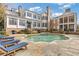 A beautiful pool area with comfortable chaise lounges and manicured landscaping at 3977 Sweet Bottom Dr, Duluth, GA 30096
