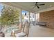 Inviting porch with rocking chairs and a swing, offering a relaxing outdoor space overlooking the pool at 3977 Sweet Bottom Dr, Duluth, GA 30096