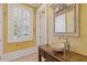 Stylish powder room featuring a vessel sink, decorative mirror, and natural light at 3977 Sweet Bottom Dr, Duluth, GA 30096