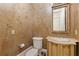 Powder room featuring designer wallpaper, decorative mirror, and marble sink at 3977 Sweet Bottom Dr, Duluth, GA 30096