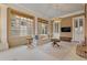 Bright sunroom with many windows, ceiling fans, and a flat screen tv at 3977 Sweet Bottom Dr, Duluth, GA 30096