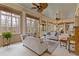 Bright sunroom with many windows, ceiling fans, and cozy seating at 3977 Sweet Bottom Dr, Duluth, GA 30096