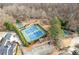 Aerial view of community tennis courts and a playground surrounded by trees and greenery at 3977 Sweet Bottom Dr, Duluth, GA 30096