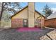 Back exterior of house with chimney, brick siding, and a patio area at 60 Mountain View Cir, Covington, GA 30016