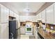 Functional kitchen with stainless steel refrigerator, granite countertops, and white appliances at 60 Mountain View Cir, Covington, GA 30016