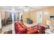 Spacious living room next to the dining area, featuring neutral walls and a comfortable red sofa at 60 Mountain View Cir, Covington, GA 30016