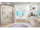 Bright bathroom featuring granite countertops, dual shower heads, a soaking tub and large mirrors at 165 Ansley Way, Roswell, GA 30075