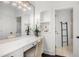 Bright bathroom featuring a sleek vanity with ample counter space and a well-lit mirror for grooming at 165 Ansley Way, Roswell, GA 30075