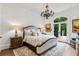 Bright bedroom features a private balcony, a chandelier, and neutral tones at 165 Ansley Way, Roswell, GA 30075