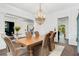 Elegant dining room features hardwood floors, a decorative chandelier, and crisp white trim at 165 Ansley Way, Roswell, GA 30075