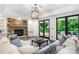 Elegant living room featuring a stone fireplace, french doors and views of the swimming pool at 165 Ansley Way, Roswell, GA 30075