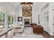 Inviting living room with fireplace, custom mantle, and large windows providing views at 165 Ansley Way, Roswell, GA 30075