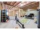 Spacious unfinished basement area with exposed framework, pink insulation, and concrete floors at 6375 Haystack Ct, Cumming, GA 30040