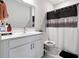 A well-lit bathroom featuring a vanity with modern fixtures and a shower-tub combo at 6375 Haystack Ct, Cumming, GA 30040