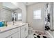 Clean bathroom featuring marble floors, white cabinets and black and white accents at 6375 Haystack Ct, Cumming, GA 30040