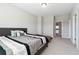 Comfortable bedroom featuring soft gray walls, carpet, and a stylish bed with modern patterned bedding at 6375 Haystack Ct, Cumming, GA 30040