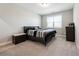 A cozy bedroom with neutral decor, plush carpet, and a window at 6375 Haystack Ct, Cumming, GA 30040