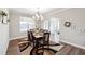 Elegant dining room with a stylish chandelier, hardwood floors, and ample natural light for hosting dinner parties at 6375 Haystack Ct, Cumming, GA 30040