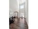 Elegant foyer features soaring ceilings, wood floors, and a decorative console table for a welcoming ambiance at 6375 Haystack Ct, Cumming, GA 30040