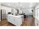 A modern kitchen featuring white cabinets and a spacious island with barstool seating at 6375 Haystack Ct, Cumming, GA 30040