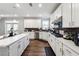 A modern kitchen featuring white cabinets and a spacious island with barstool seating at 6375 Haystack Ct, Cumming, GA 30040