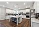 A modern kitchen featuring white cabinets and a spacious island with seating at 6375 Haystack Ct, Cumming, GA 30040