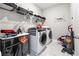 Functional laundry room with modern washer and dryer, storage shelves, and practical design at 6375 Haystack Ct, Cumming, GA 30040