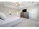 An expansive main bedroom with a trey ceiling, carpet, and a full dresser with TV at 6375 Haystack Ct, Cumming, GA 30040