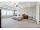 Spacious main bedroom with trey ceilings, large windows, and a neutral color palette, creating a serene atmosphere at 6375 Haystack Ct, Cumming, GA 30040