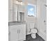 Bathroom with vanity, toilet, shower, and window at 697 Fayetteville Road, Atlanta, GA 30316