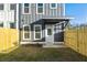 Charming home showcasing gray vertical siding, a white door, covered entry and a freshly fenced yard at 697 Fayetteville Road, Atlanta, GA 30316