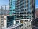 Close exterior of the building, revealing modern balconies, numerous windows, and greenery at 1080 Peachtree Ne St # 2807, Atlanta, GA 30309