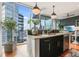 Modern kitchen with breakfast bar, stylish pendant lights, and scenic views at 1080 Peachtree Ne St # 2807, Atlanta, GA 30309