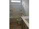 Bright bathroom with a shower-tub combo, modern vanity, and wood-look flooring at 3086 Zodiac Ct, Lawrenceville, GA 30044