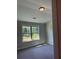 Cozy bedroom featuring a window with a view of the outdoors, complemented by plush carpeting at 3086 Zodiac Ct, Lawrenceville, GA 30044