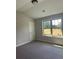 Comfortable bedroom with a large window offering natural light and a neutral color scheme at 3086 Zodiac Ct, Lawrenceville, GA 30044