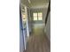 Hardwood style flooring leads to a bright window and staircase at 3086 Zodiac Ct, Lawrenceville, GA 30044