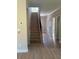Hallway with wood-look flooring and view of carpeted stairs at 3086 Zodiac Ct, Lawrenceville, GA 30044