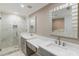 Bathroom features a double vanity, modern faucets, and tiled walk-in shower with recessed shelving at 3186 Quail Ct, Decatur, GA 30034