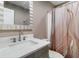 Bathroom featuring modern fixtures, vanity with white countertop and beautifully tiled shower with glass door at 3186 Quail Ct, Decatur, GA 30034