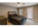 Cozy bedroom features neutral walls, carpeted floors, ceiling fan, and door to the outside at 3186 Quail Ct, Decatur, GA 30034
