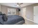 Bedroom features a ceiling fan, neutral walls, and natural light from the windows and en suite access at 3186 Quail Ct, Decatur, GA 30034