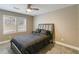 This is a cozy bedroom featuring carpeted floors, a ceiling fan, and two sunny windows at 3186 Quail Ct, Decatur, GA 30034