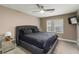 Bedroom featuring a ceiling fan, mounted tv, neutral walls, and a window for ample natural light at 3186 Quail Ct, Decatur, GA 30034
