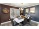 Stylish dining room with sleek lighting and elegant wood panel accent wall at 3186 Quail Ct, Decatur, GA 30034