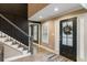 Warm entryway featuring a stylish black front door and staircase with black spindles at 3186 Quail Ct, Decatur, GA 30034