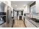 Well-lit kitchen features stainless steel appliances, white cabinetry, gray countertops, and an open floor plan at 3186 Quail Ct, Decatur, GA 30034