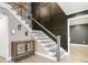 Entryway staircase featuring iron railing, decorative wall trim, and decorative wood cabinet at 3186 Quail Ct, Decatur, GA 30034