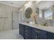 Bathroom featuring double vanity with marble countertop, decorative mirrors, and lighting at 1253 Lucile Sw Ave, Atlanta, GA 30310